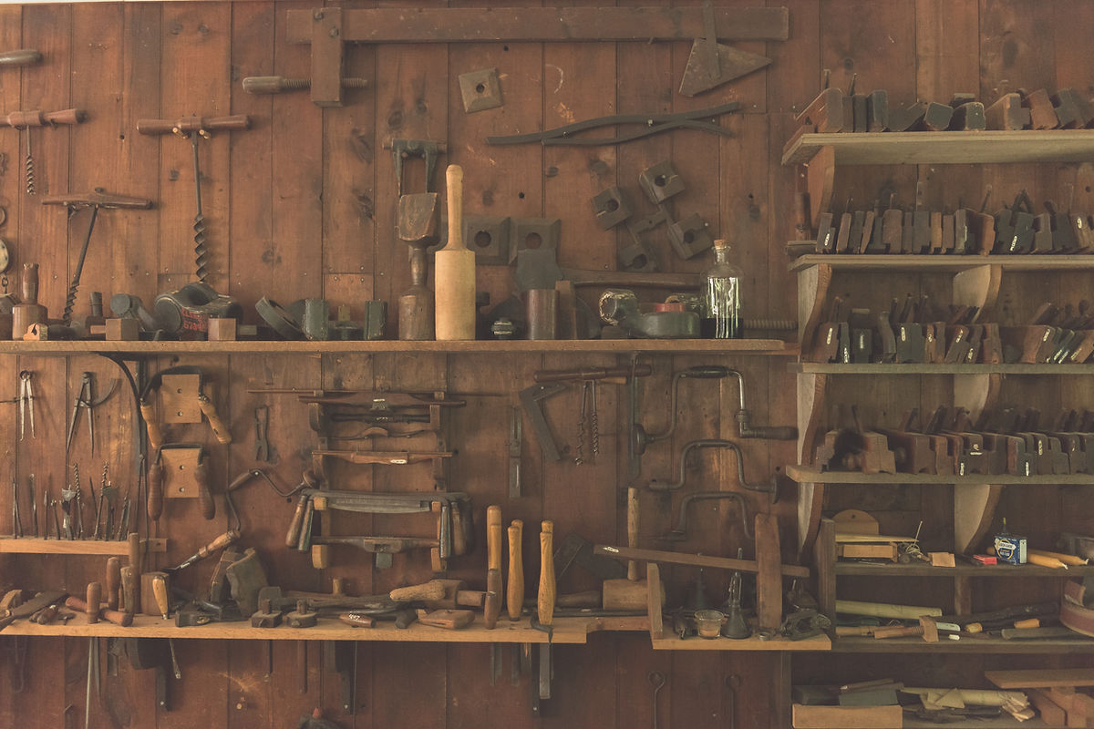 The business's own tool shed: generations of hand tools on wooden shelves